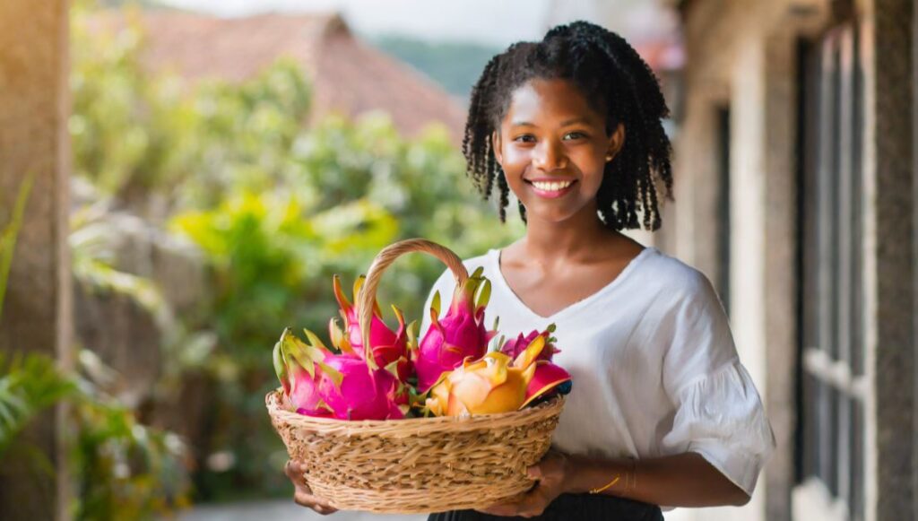 A Young women with a basket full of dragon fruits