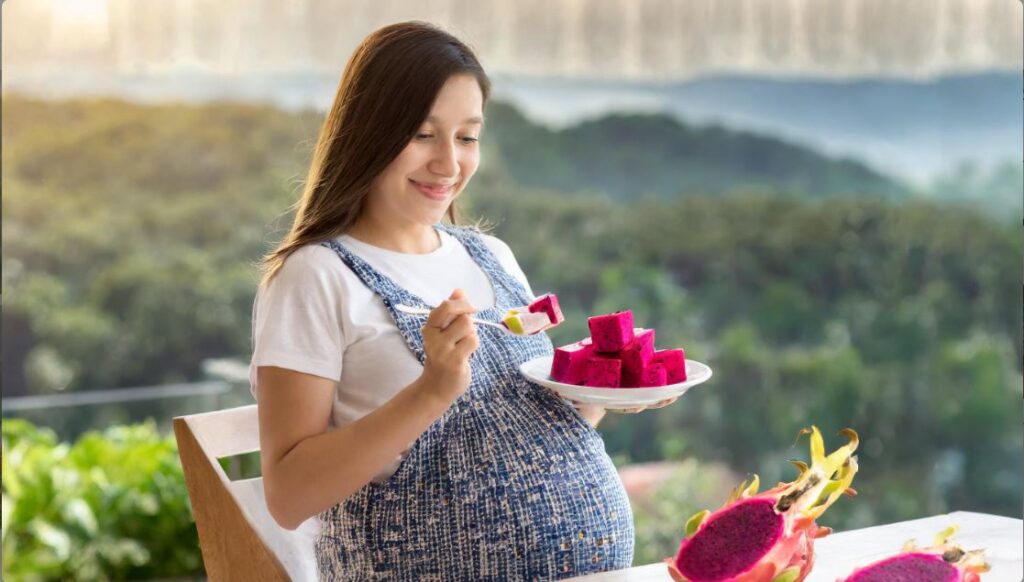 A pregnant woman eating dragon fruit